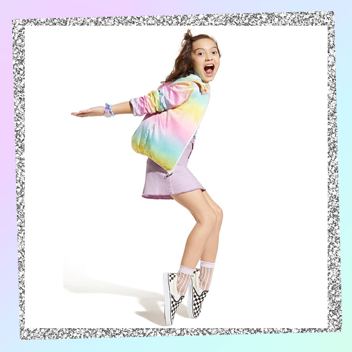 Tween girl wearing a rainbow pastel jacket