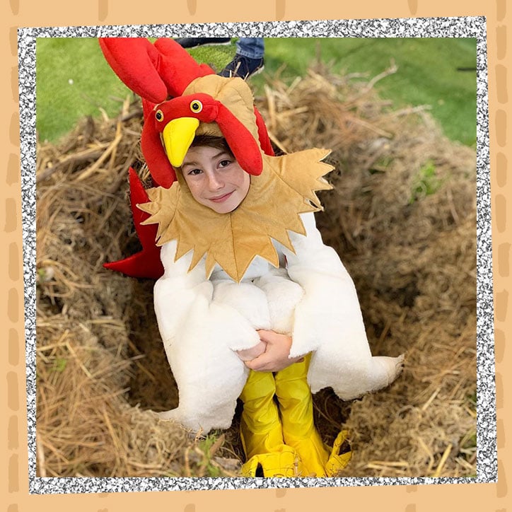 Actor Paxton Booth wearing a chicken suit while sitting in a nest