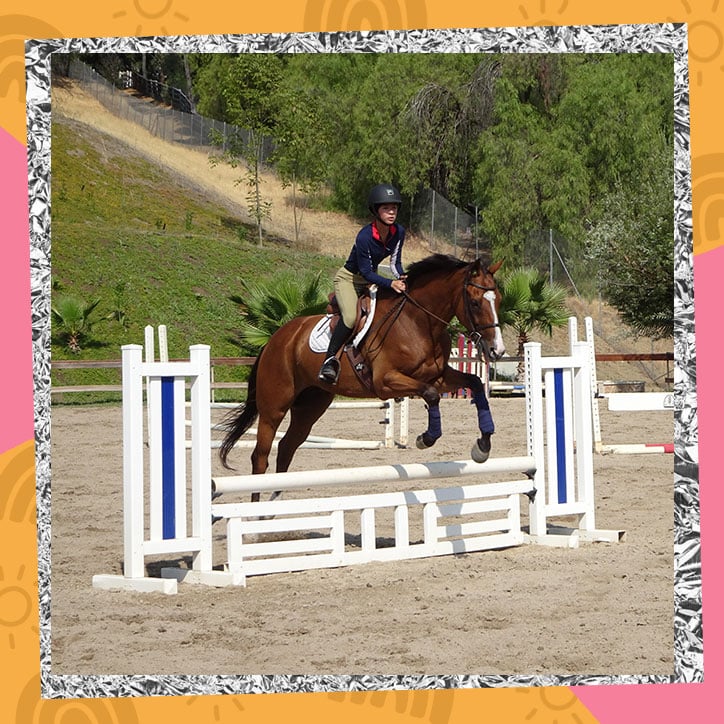 Aubrey Anderson-Emmons performing a jump while riding a horse