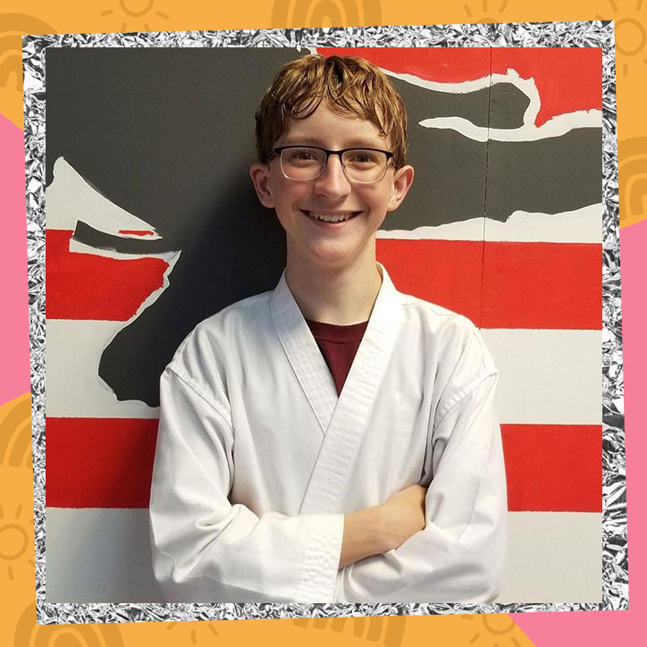 Owen Morgan poses in a karate uniform after receiving his black belt