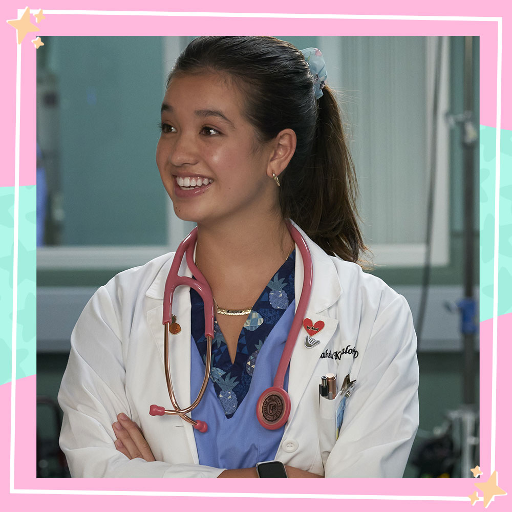 Peyton Elizabeth Lee in character as Lahela Kameahola, in her doctor coat and scrubs