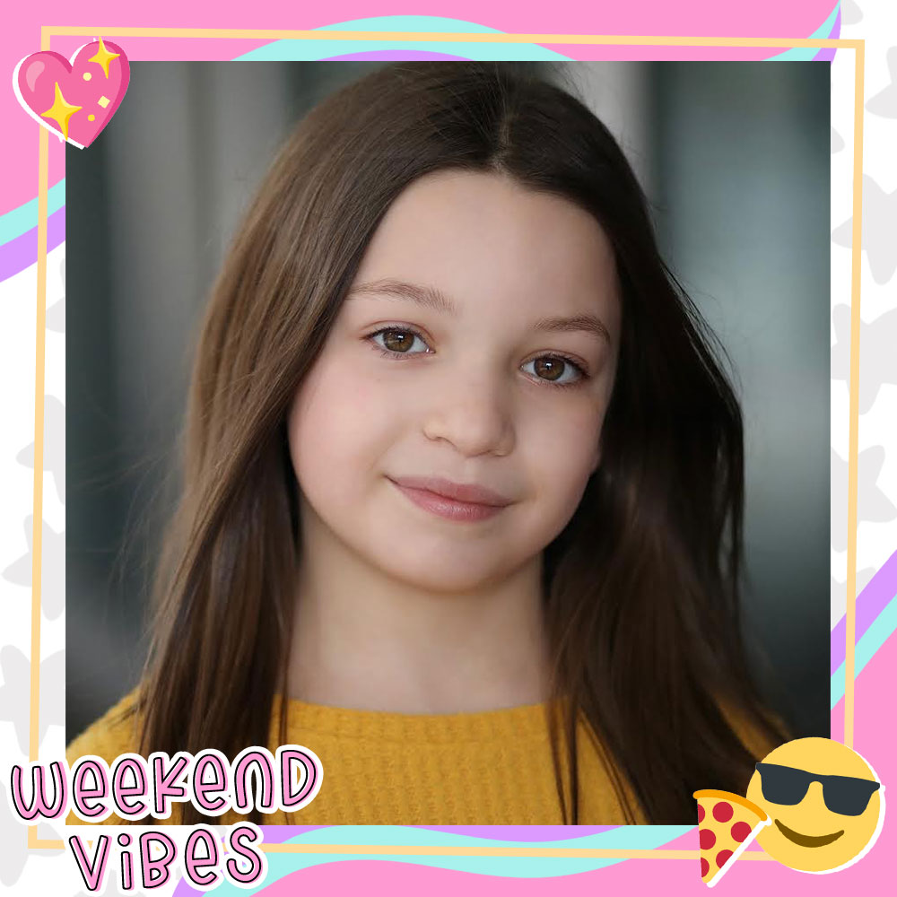 Closeup of Dalya Knapp with long brown hair flowing over a mustard yellow sweater