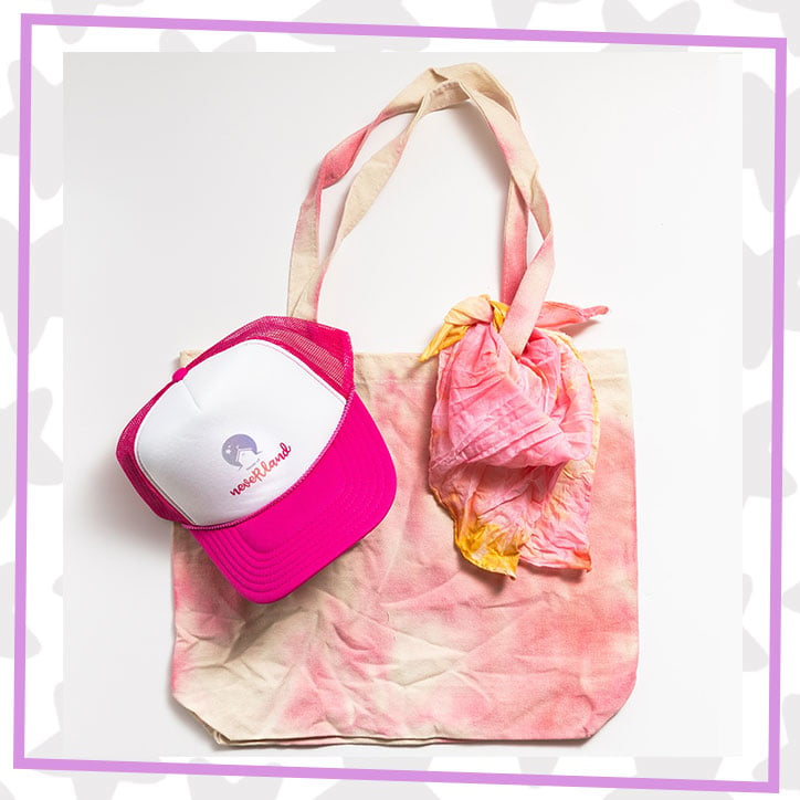 A flaylay featuring a house of neveRland hat, custom dyed pink tote and hankie, as well as a house of neveRland hat 