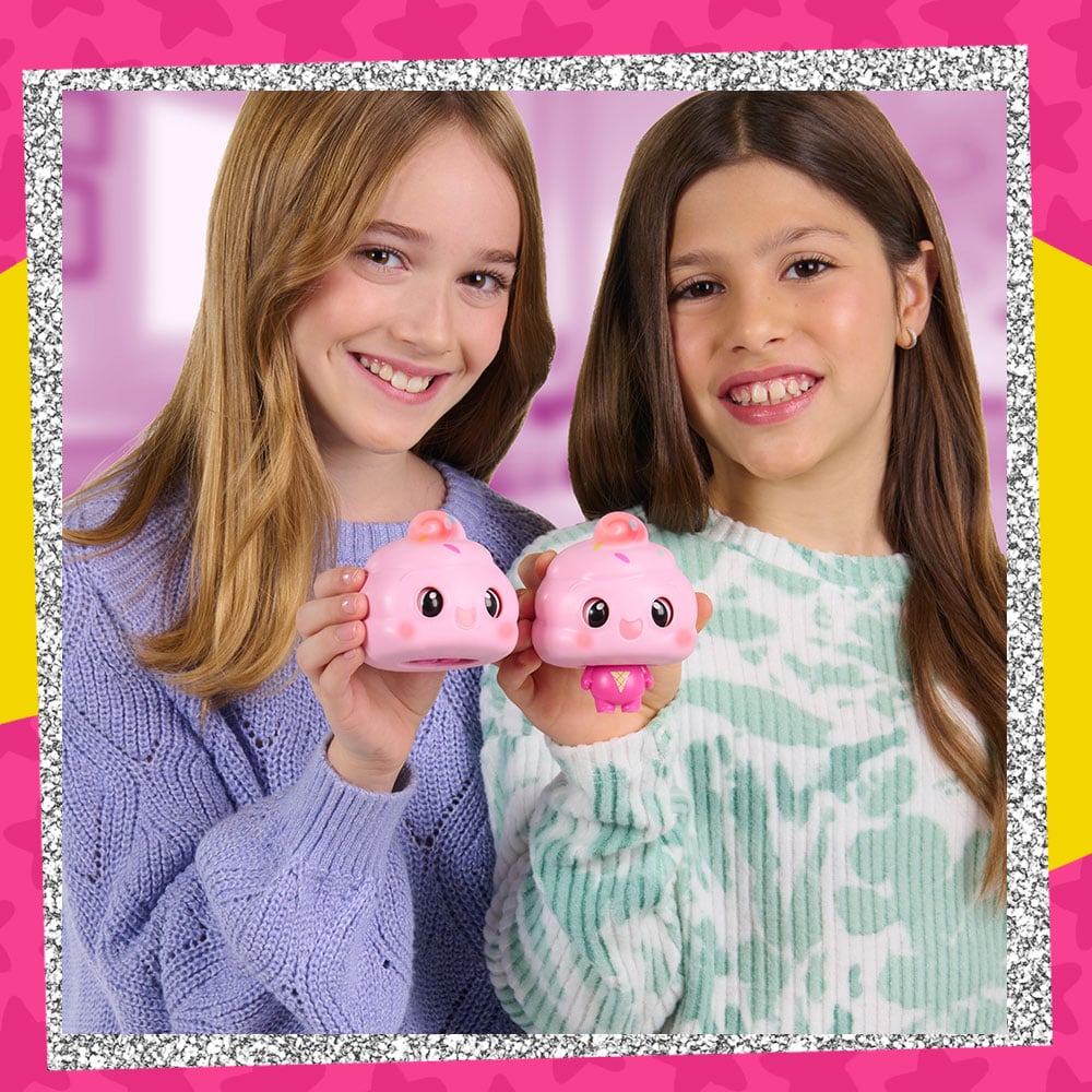 Lifestyle photo of two tween girls holding up the My Squishy Little Ice Cream figure. One has the body popped out and the other is in it's pre-squished state.