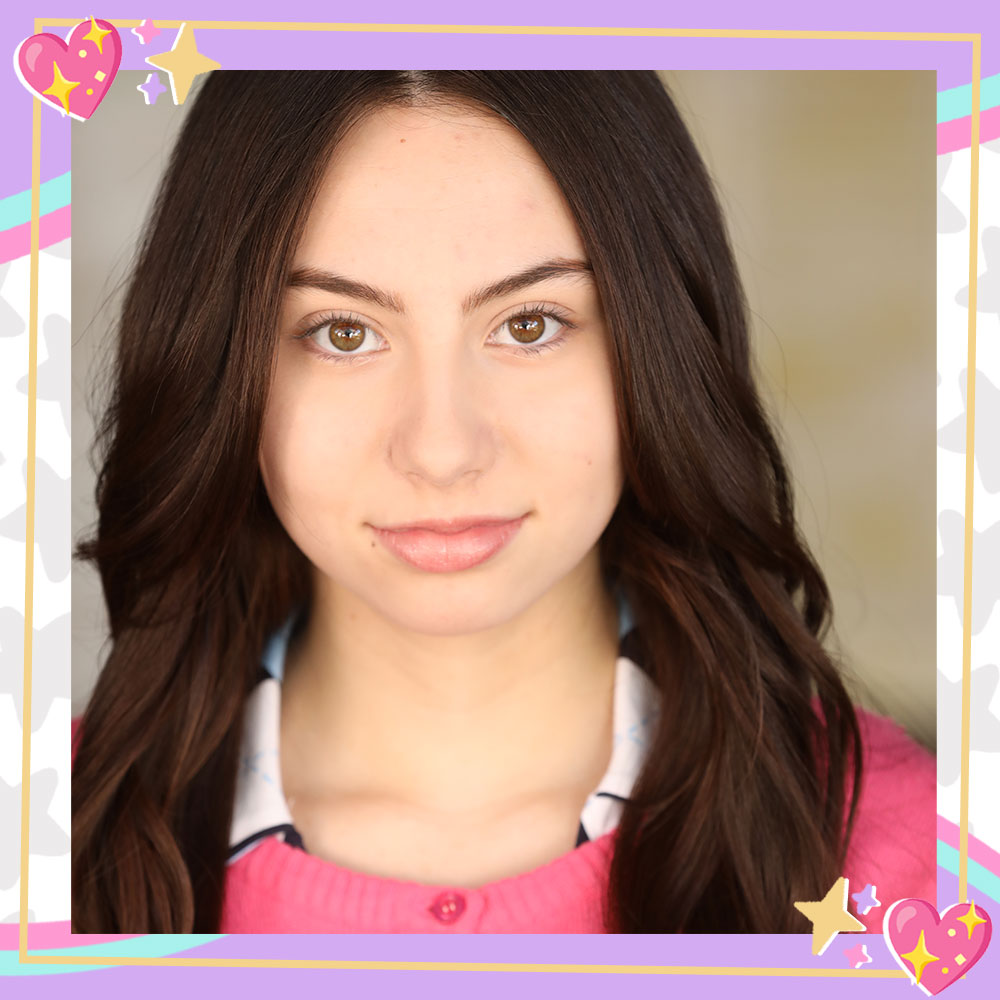 Closeup headshot of Lola Raie in a pink sweater