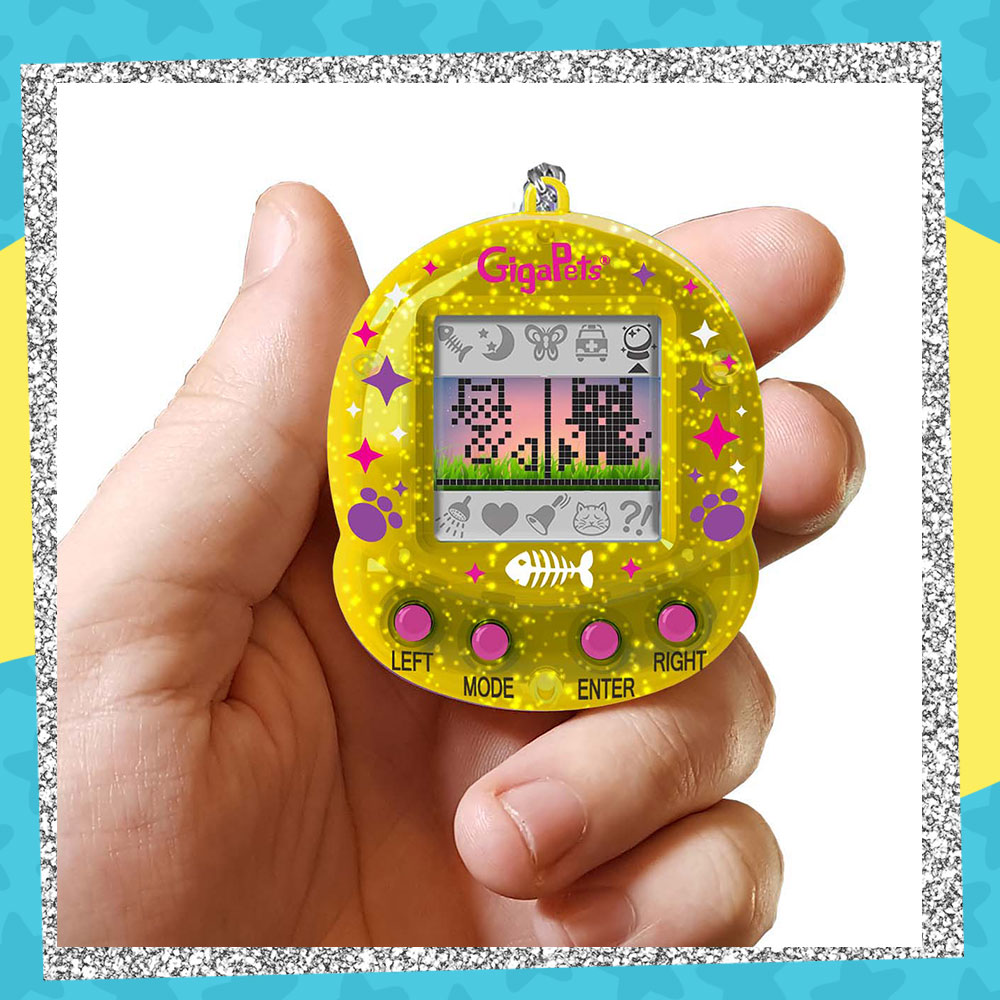 Hand holding up a GigaPets CompuKitty/StarCat 25th Anniversary virtual pet