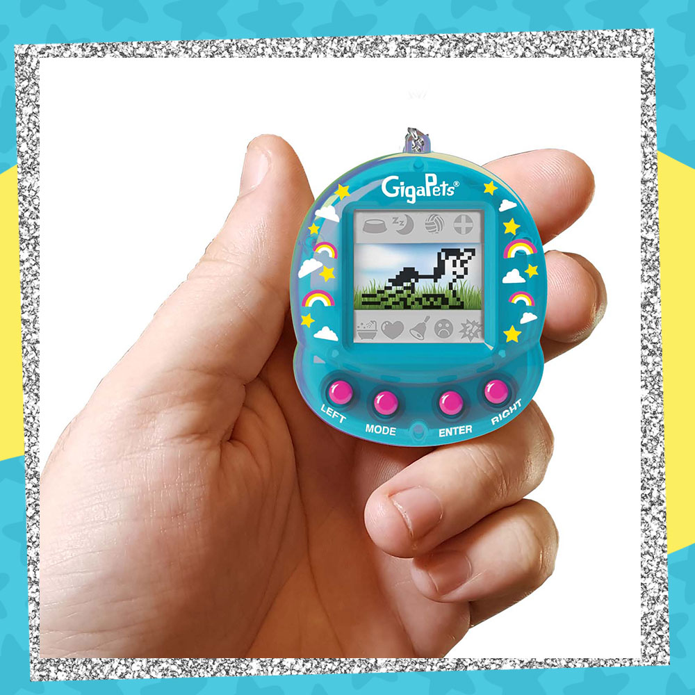 Hand holding up a GigaPets Virtual Unicorn virtual pet