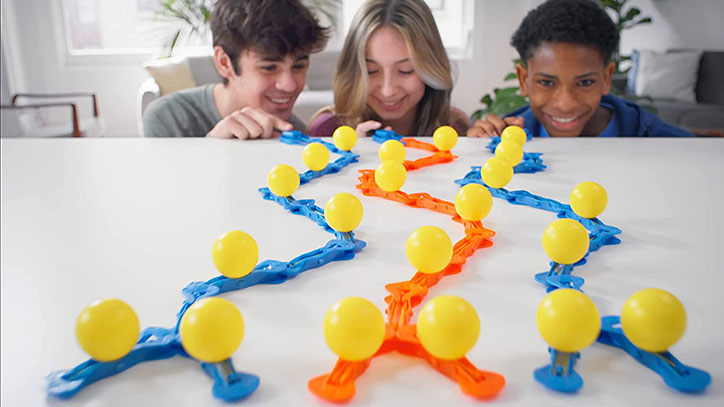 Lifestyle photo of three kids sitting at a table about to launch a ZipLinx run.