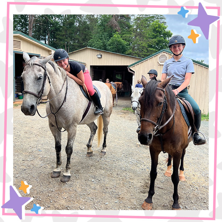 Cilla and Maddy from JKrew in riding gear, riding horses at their local stable