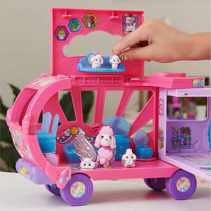Lifestyle photo of the Hatchimals CollEGGtibles Rainbowcation Camper all set up with a family of poodle Hatchimals inside