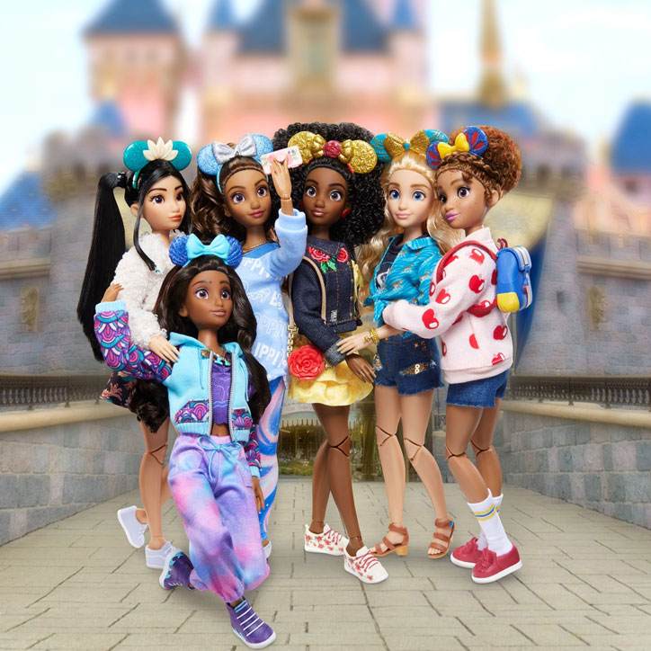 All six Disney ily 4EVER fashion dolls posing for a squad selfie in front of Sleeping Beauty's Castle at Disneyland