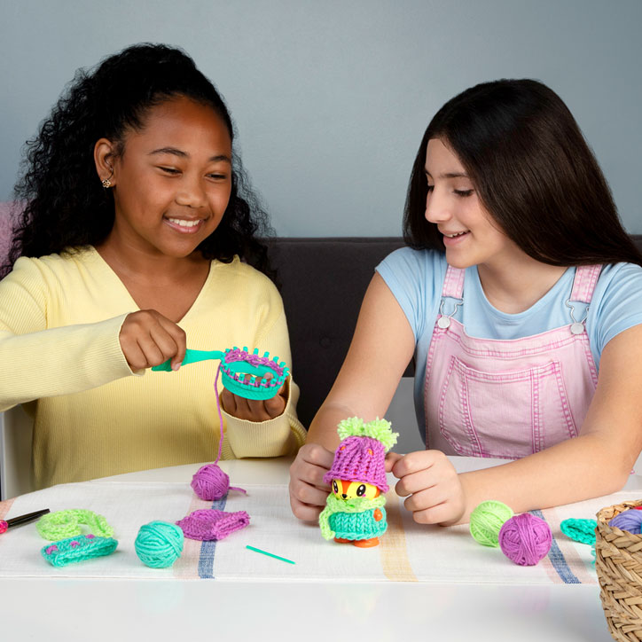 Two tween girls knitting the Fox Little Knitty Bittys kit