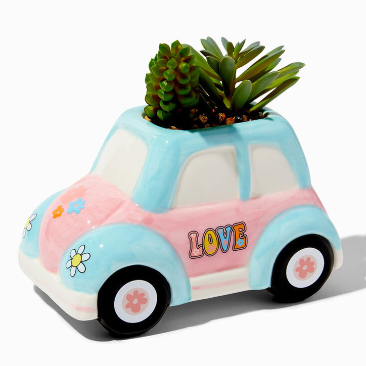 Pastel pink and blue VW Beetle planter with a faux succulent plant sticking up out of the room and the word "LOVE" in a retro font on the door
