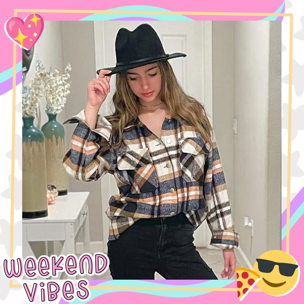 Ariana Nunez poses in a cropped flannel and rimmed black hat