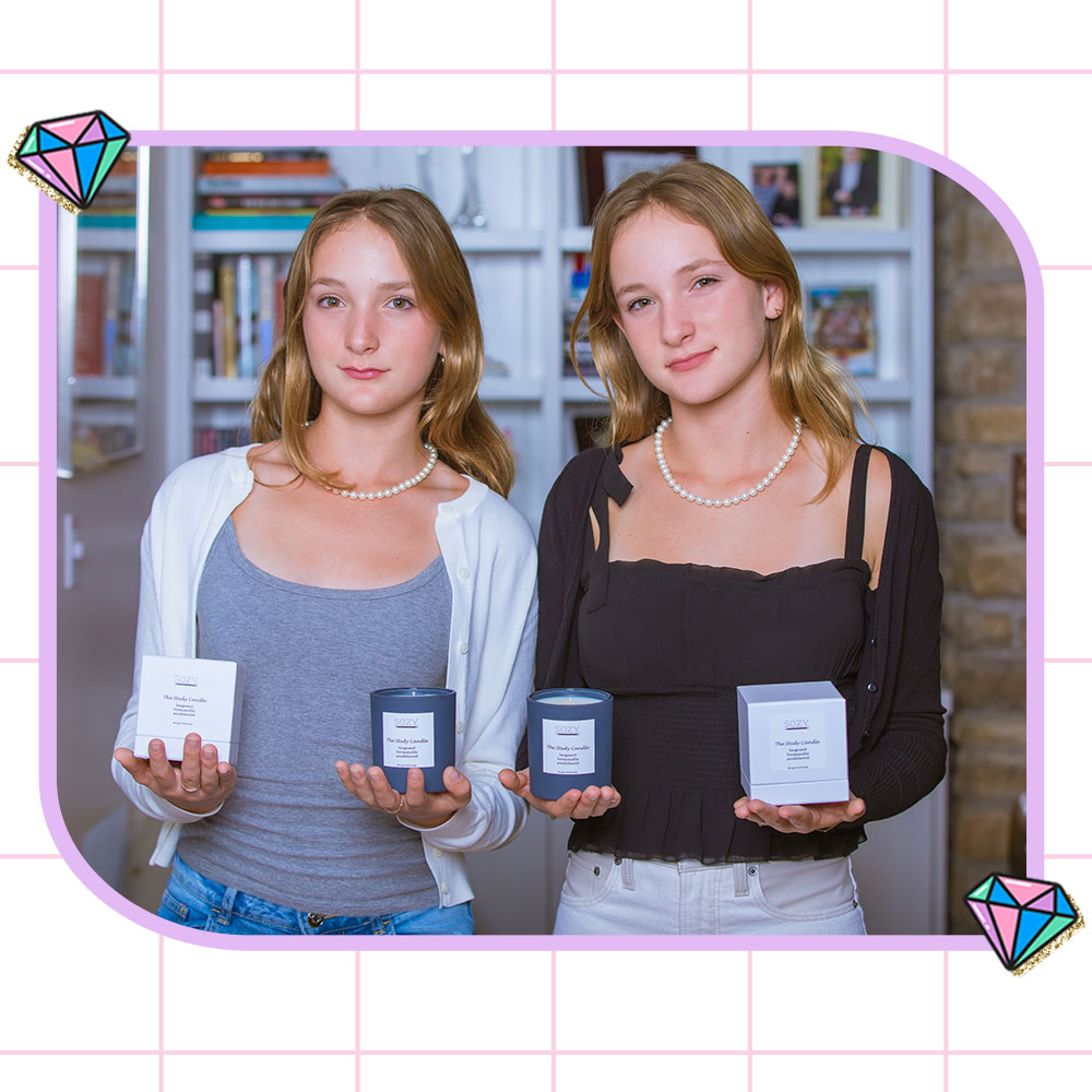 Sophie and Izzy, Founders of SOZY, holding their new Study Candle product