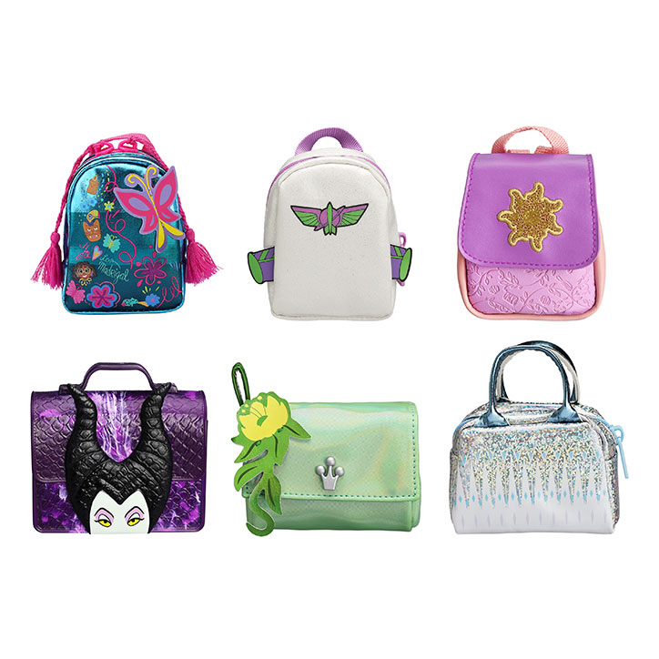 The full collection of Real Littles Disney Bags laid out in a row, featuring Encanto, Buzz Lightyear, Tangled, Maleficent, Tiana, and Frozen inspired collectible mini bags.