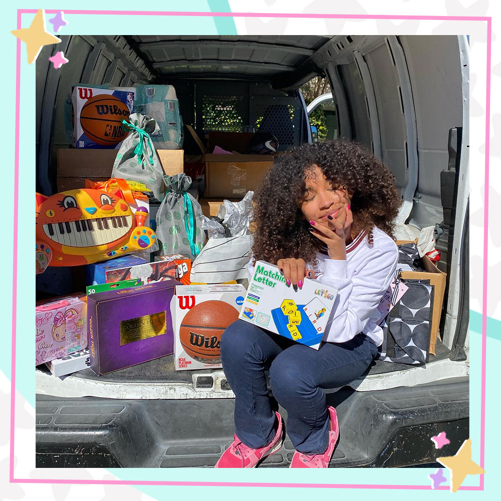 Jordyn Curet sitting in the back of a van filled with toys donated to her charity, Jordyn's Joy