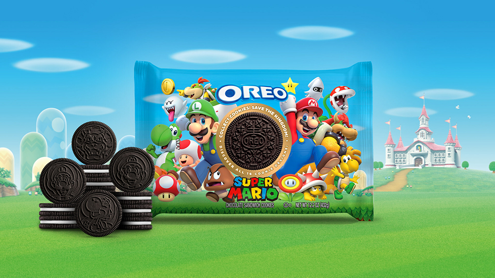 A package of Super Mario Oreos on a Mushroom Kingdom backdrop. OREO cookies are stacked next to the package, some of them flipped to show the characters on the face of the cookie.