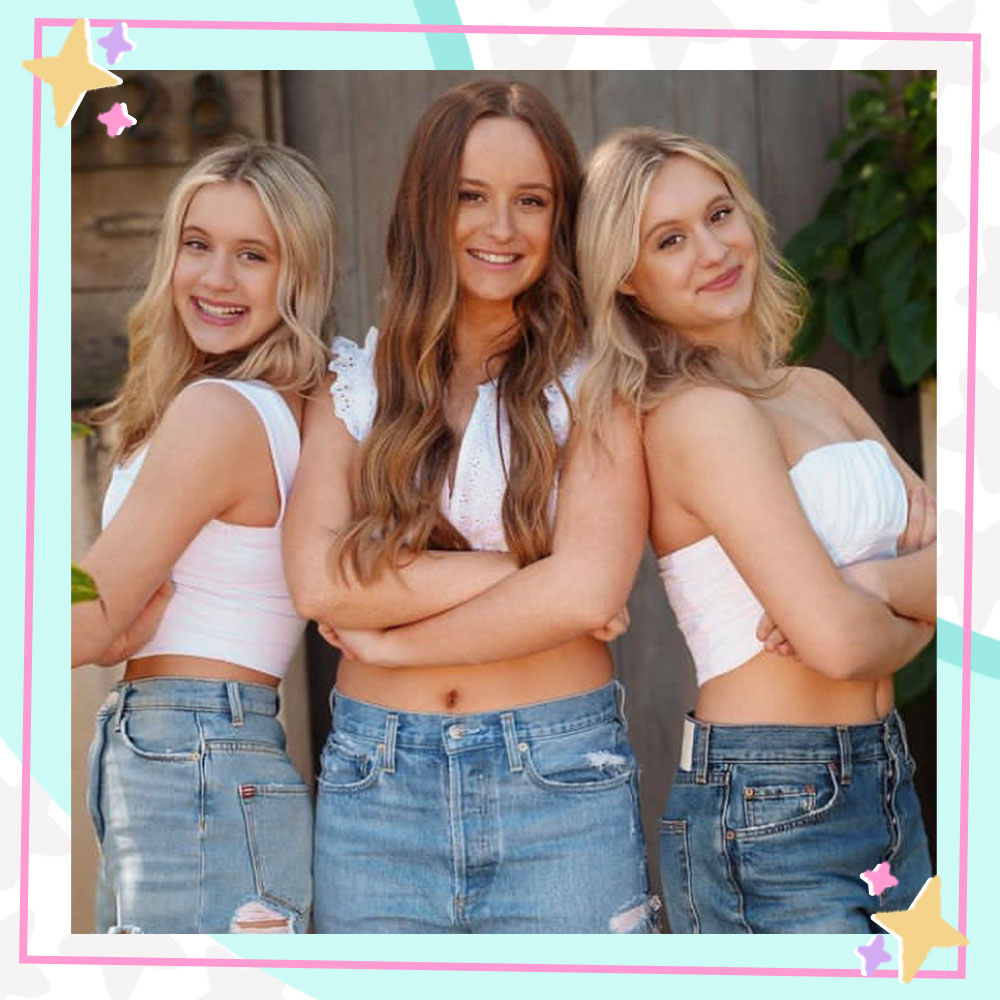 Couch Sisters Kameron, Mackenzie, and Katie Couch stand together in matching white tops and jeans.