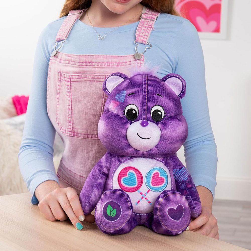 Tween girl posing with Share Bear from the Care Bears Denim Collection